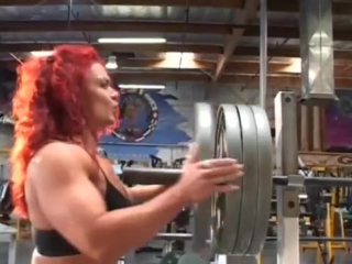 muscular woman bending steel after hard workout